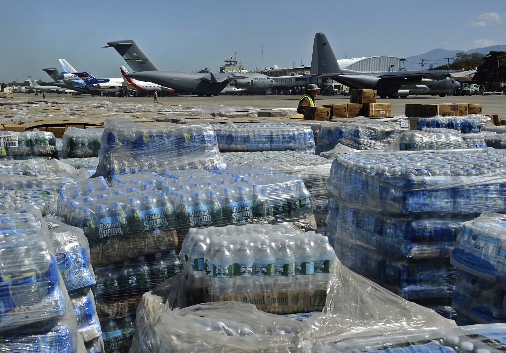 100128-N-5345W-098 PORT-AU-PRINCE, Haiti (Jan. 28, 2010) Pallets of humanitarian aid and bottled water are lined up in a staging area just off the tarmac of Aerodome de Jacmel, an airport in Port-au-Prince, while cargo planes from various nations sit at the airport's terminal facility. The multi-purpose amphibious assault ship USS Bataan (LHD 5) and the amphibious dock landing ships USS Fort McHenry (LSD 43), USS Gunston Hall (LSD 44) and USS Carter Hall (LSD 50) are participating in Operation Unified Response as the Bataan Amphibious Relief Mission by providing military support capabilities to civil authorities to help stabilize and improve the situation in Haiti in the aftermath of a 7.0 magnitude earthquake on Jan. 12, 2010. (U.S. Navy photo by Mass Communication Specialist 2nd Class Kristopher Wilson/Released)